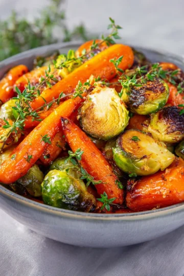 Golden roasted Crispy Maple Glazed Carrots and Brussel Sprouts fresh from the oven.